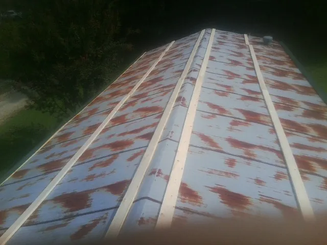 Rusted metal roof panels with new wood purlins before replacement — Storm Damage Roof Repair in Venus by Roofing Brothers