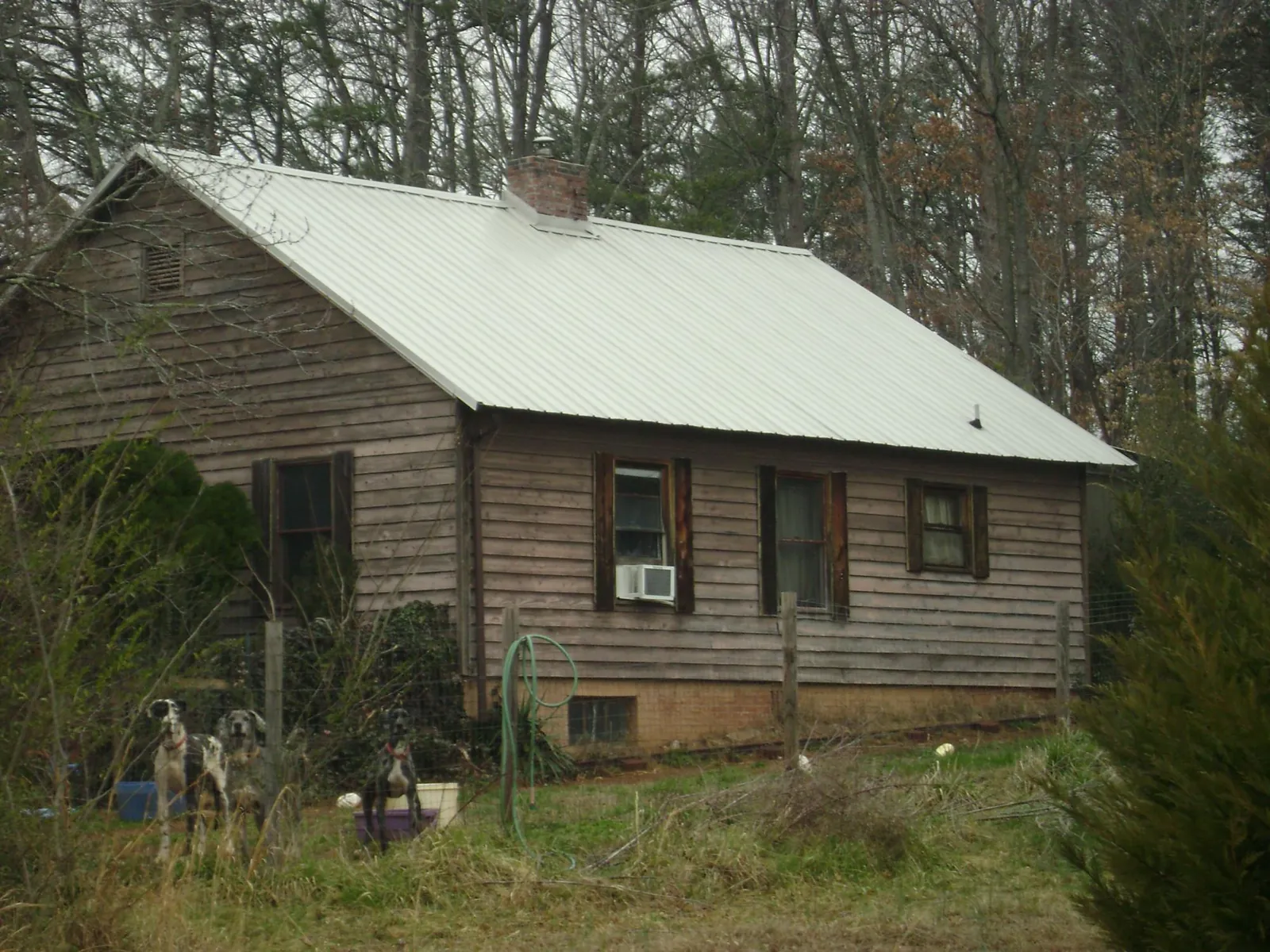 White metal roof on an old wood sided farmhouse, from a Metal Roof Installation job in Venus