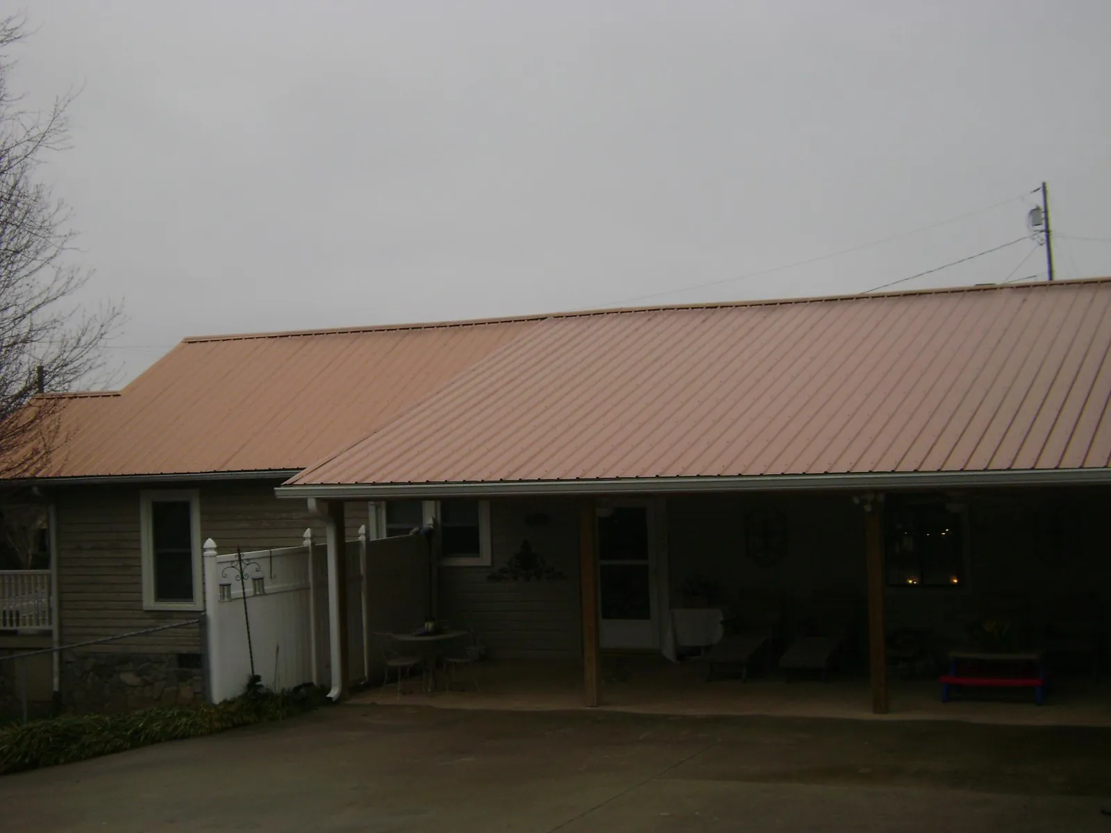 Copper toned metal roof over a wide covered patio in Venus